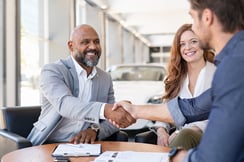 couple-buying-new-car-at-car-dealership